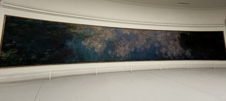 One of a series of Claude Monet's Waterlilies at the Musée de l'Orangerie. Juveny Pond, dark blue with deep green leaves in places and light in the middle in pale pink and purple-blue.